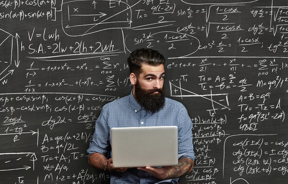 Brutal bearded man on a chalkboard background