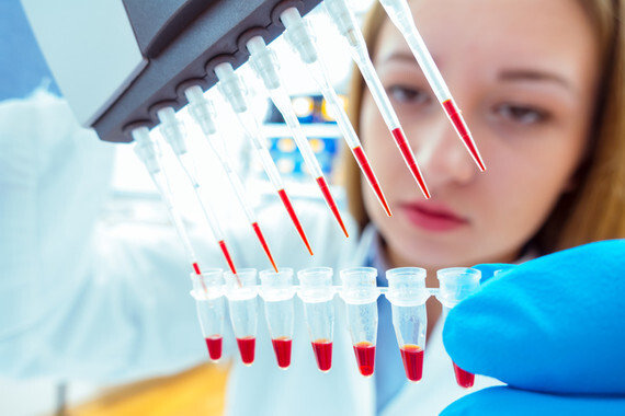 woman assistant in laboratory with multi pipette in the clinic, the research of cancer stem cells