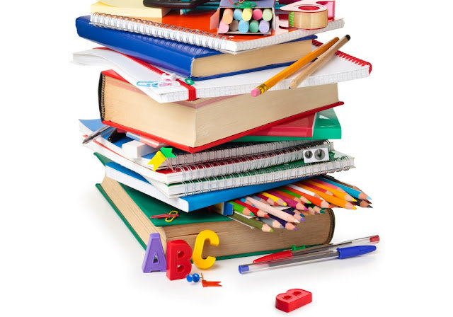 School supplies and green apple isolated on white background.